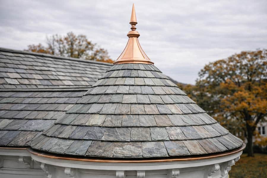Copper cupola or turret roof detail on a historic building, showing conical copper cap with weathering